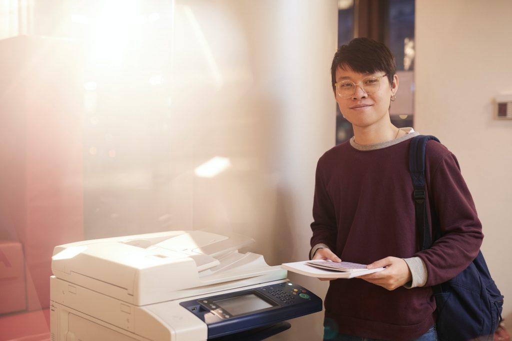 Asian man using printer
